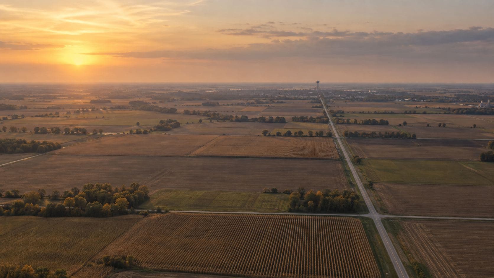Farm fields at dusk under a wide sky